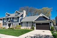 Beautiful suburban family home with attached garage and landscaped lawn representing FHA homeowner financing, residential mortgage loans, vacation residence mortgage, self employed refinance, and rental property mortgage options for homeowners, first-time buyers, self-employed borrowers, and real estate investors seeking home financing solutions.